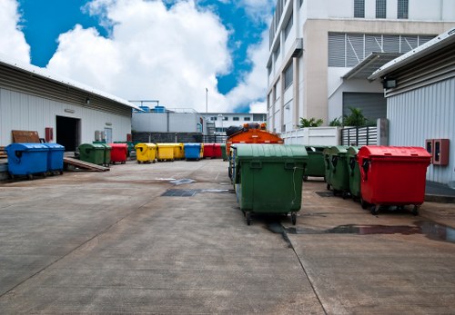 Traffic marshal directing a refuse vehicle on a commercial site