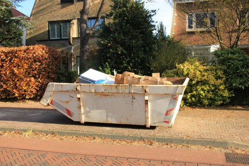 Man and van loading bulky items from a terrace property in Luton